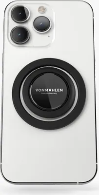 A white smartphone with a black magnetic phone holder attached to the back.