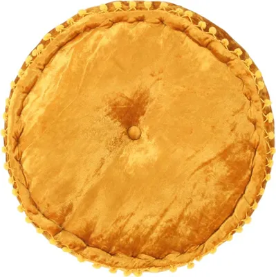 A round, mustard yellow velvet pouf with a button in the center and a pom-pom trim around the edge, presented on a white background.