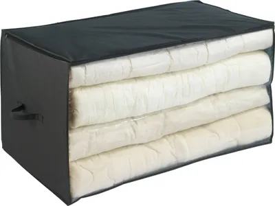 A storage bag filled with folded bedding.