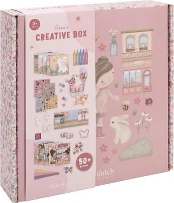 A pink cardboard box for a creative craft kit, decorated with floral patterns and illustrations of a girl, a bunny, and various craft supplies.