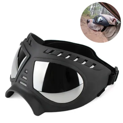 A black dog goggle is shown in the foreground, with a smaller inset image of a dog wearing similar goggles in a car.