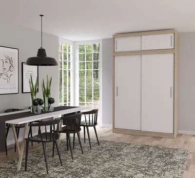 A dining room with a table, chairs, and a wardrobe.