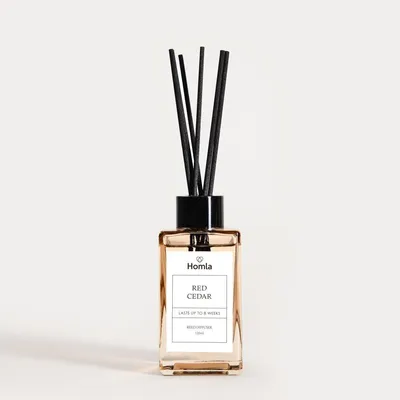 A product shot of a reed diffuser with a white background.