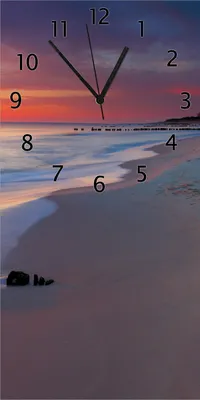 Produktbild von Wallario Design Wanduhr bedruckt, Größe 30 x 60 cm, Motiv: Farbenspiel im Himmel - Sonnenuntergang am Strand
