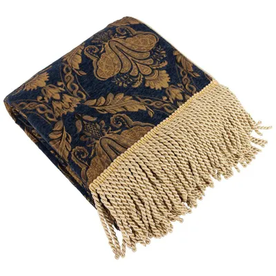 A folded throw blanket with a damask pattern and fringe.