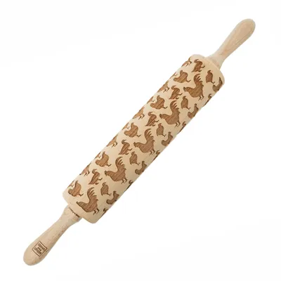 A wooden rolling pin with a chicken pattern engraved on it, placed on a white background.