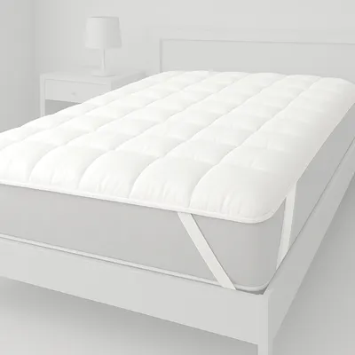 A white mattress topper on a bed.