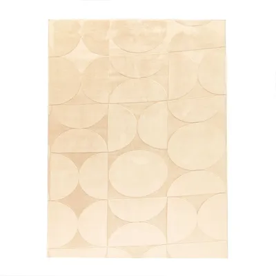 A flat lay of a rug with a geometric pattern of circles and semi-circles.