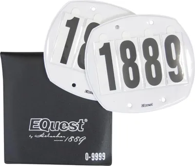 A black pouch and two white start numbers with black digits are displayed against a white background.