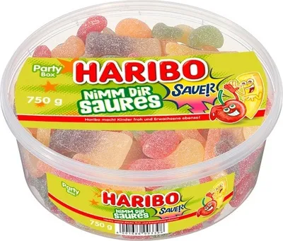 A clear, well-lit studio shot of a large, clear plastic tub filled with colorful gummy candies, with a prominent branded label.