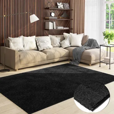 A living room scene featuring a sectional sofa, a floor lamp, shelves with decor, and a black rug in the foreground.