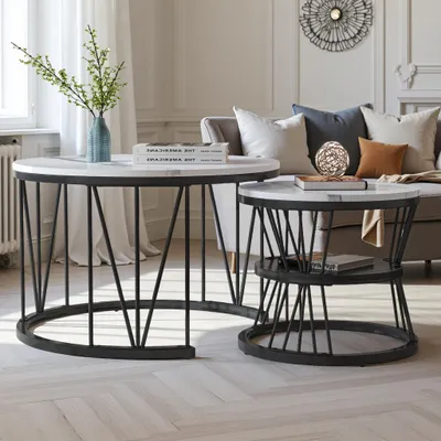 A living room setting with two nesting coffee tables, a sofa, and decorative items.