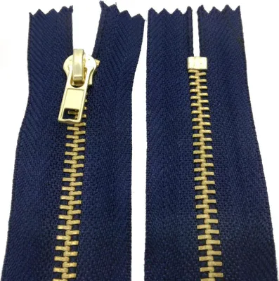 A close-up view of a dark blue zipper with gold-colored teeth and slider.