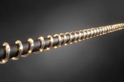 A close-up shot of a black rod with a string of warm white LED lights wrapped around it in a spiral pattern.
