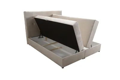 A beige upholstered bed frame with its storage compartments open, revealing the interior.