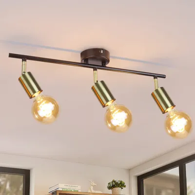 A three-bulb ceiling light fixture with a black bar and gold accents, mounted on a white ceiling.