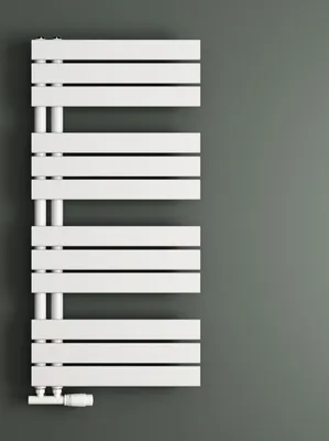 A white radiator against a gray wall.
