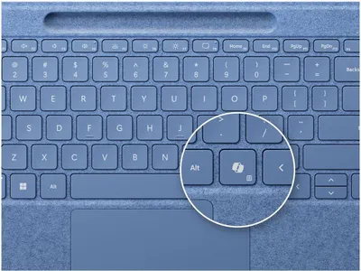 A close-up view of a blue keyboard with a magnifying glass highlighting a specific key.