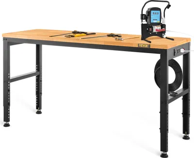 A workbench with tools and a testing device on it, set against a white background.