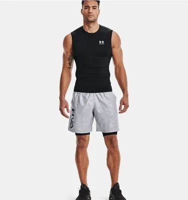 A man wearing athletic clothing stands against a white background.