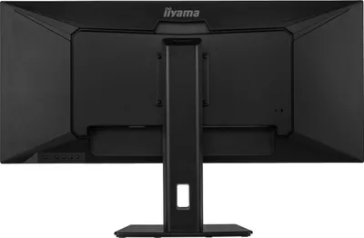 The back of a black computer monitor on a black background.