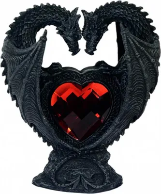 A black sculpture of two dragons forming a heart shape around a red crystal heart.