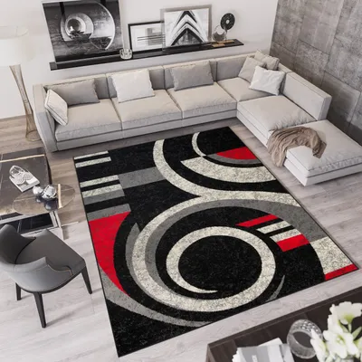 A modern living room with a sectional sofa, coffee table, and a patterned rug.