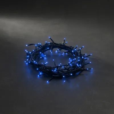 Produktbild von Konstsmide - Microlight Lichterkette, verschweißt, mit 8 Funktionen, Steuergerät und Memoryfunktion, 100 blaue Birnen, 24V Außentrafo, schwarzes Kabel ; 2083-400