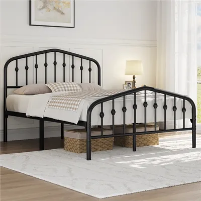 A black metal bed frame with a crown motif headboard is shown in a bedroom setting.