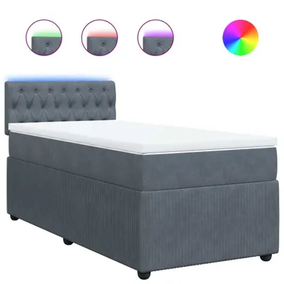 A dark gray box spring bed with a tufted headboard and a white mattress topper, illuminated by blue LED lights along the headboard. Three circular insets above the bed show the headboard with different colored LED lights (green, red, purple), and a color w