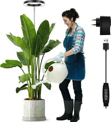 A woman waters a large potted plant under a ring-shaped LED grow light. Accessories for the light are shown on the right.