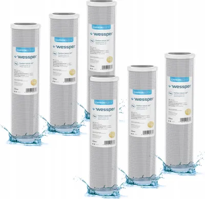 A group of water filter cartridges are arranged with water splashing around their bases.