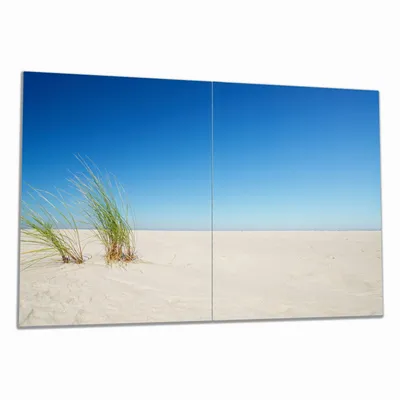 Produktbild von Wallario Herdabdeckplatte aus Glas, Größe 80 x 52 cm 2-teilig, Motiv Sandstrand unter blauem Himmel
