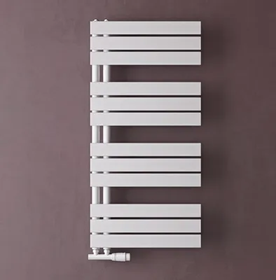 A white radiator against a brown wall.