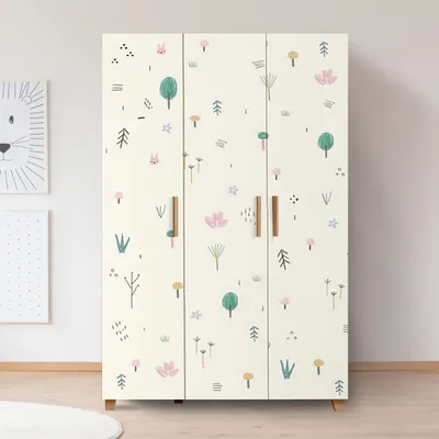 A three-door wardrobe with a playful jungle-themed print, set in a room with a light-colored wall and floor.