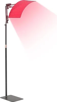A red light therapy panel with a stand, emitting red light.