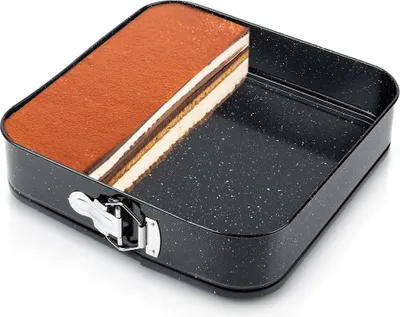 A square springform cake pan with a slice of tiramisu cake inside.