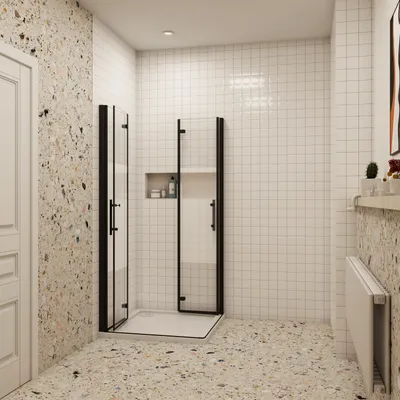 A modern bathroom with a shower cabin, terrazzo flooring, and tiled walls.