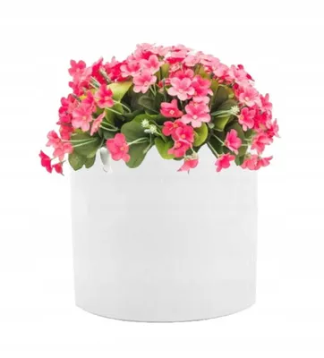 A white cylindrical pot filled with pink artificial flowers and green leaves, set against a white background.