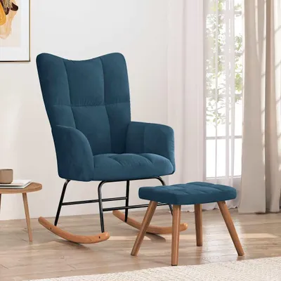 A blue velvet rocking chair with a matching ottoman is shown in a well-lit room with sheer curtains in the background.