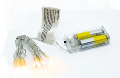 A string of battery-powered LED lights with a battery pack and a label.