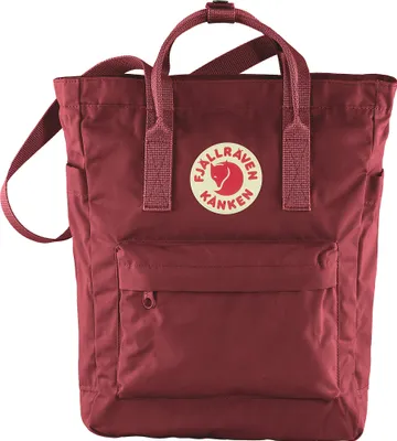 A studio shot of a red Fjällräven Kånken Totepack Rucksack.