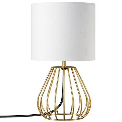 A close-up studio shot of a gold and white table lamp.