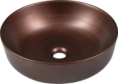 A close-up, studio shot of a copper-colored vessel sink with a drain hole in the center.