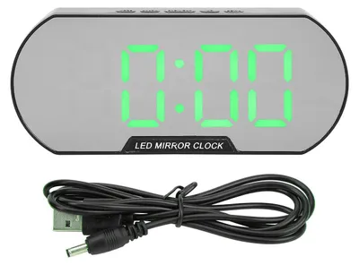 A digital alarm clock with a USB cable on a white background.