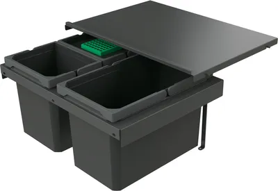 A dark gray pull-out trash bin system with two compartments and a green insert, shown with the lid open.