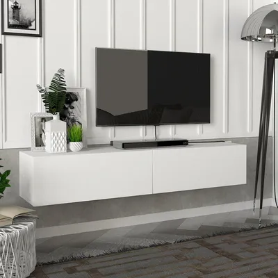 A white floating media console with a television mounted above it, placed against a white paneled wall.