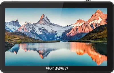 A black Feelworld monitor displaying a scenic mountain landscape with a lake in the foreground.