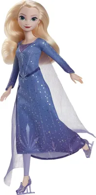 A doll dressed as a figure skater, posed in a dynamic stance.