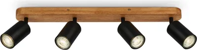 A four-light ceiling spotlight fixture with black cylindrical lamps mounted on a wooden bar.